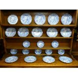 A SET OF WILLOW PATTERN DRESSER PLATES, fourteen dinner plates and eight side plates as displayed on