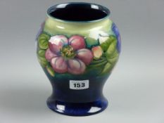 A MOORCROFT CLEMATIS VASE, a 17 cms high globular vase patterned on a tonal green blue ground,