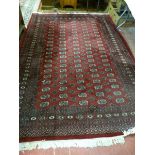 AN IRANIAN CARPET, red ground classically styled with tasselled ends, 286 x 190 cms approximately