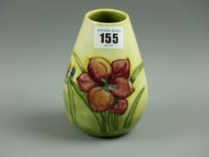 A MOORCROFT FREESIA VASE, a 13 cms high vase decorated on a yellow green ground, 'Moorcroft Potter