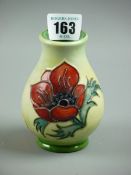 A MOORCROFT POPPY VASE, a 10 cms high trial vase decorated on a cream ground, impressed marks to the