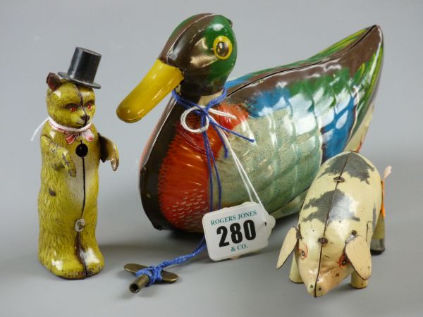 THREE TINPLATE CLOCKWORK ANIMALS including a dancing bear in bow tie and top hat (unknown maker),