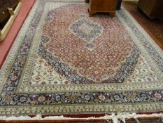 A LARGE INDO-PERSIAN CARPET, classically patterned wide bordered with tasselled ends, 347 x 250