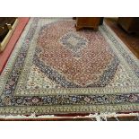 A LARGE INDO-PERSIAN CARPET, classically patterned wide bordered with tasselled ends, 347 x 250