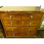 A VICTORIAN MAHOGANY CHEST of two short over three long drawers with turned rosewood and mother of