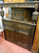 A REPRODUCTION OAK COURT CUPBOARD, quality carved with substantial pineapple style supports,