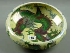 A BURSLEY WARE DRAGON PATTERNED BOWL, a lustre decorated design by Frederick Rhead, 24 cms