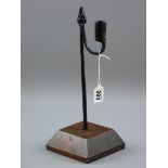 AN 18TH CENTURY RUSH LIGHT HOLDER, 32 cms tall iron rush nip with sconce counterweight in a slightly