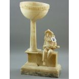 AN ALABASTER LAMP BASE carved as a mandolin playing Pierrot seated on a wall, square based reeded