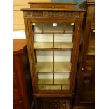 AN OAK DISPLAY CABINET, 1930's with railback single glazed door and fixed interior shelves on barley