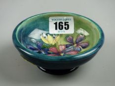 A MOORCROFT SPRING FLOWERS BOWL, an 11.5 cms footed bowl, interior decorated on a blue green ground,