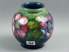 A MOORCROFT CLEMATIS VASE, a 16 cms high globular vase decorated on a blue green ground, Moorcroft