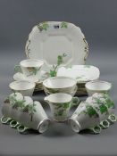 AN ART DECO CHINA TEA SET BY WELLINGTON CHINA, thirty plus pieces in green floral decoration with
