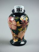 A MOORCROFT OBERON VASE, a 10 cms high baluster vase decorated on a deep green and pink