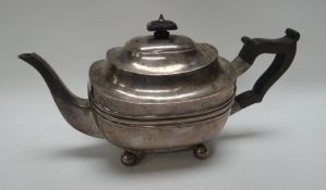 A SILVER TEAPOT of oval form on ball feet with composition handle and knop, London 1917, 13.2ozs