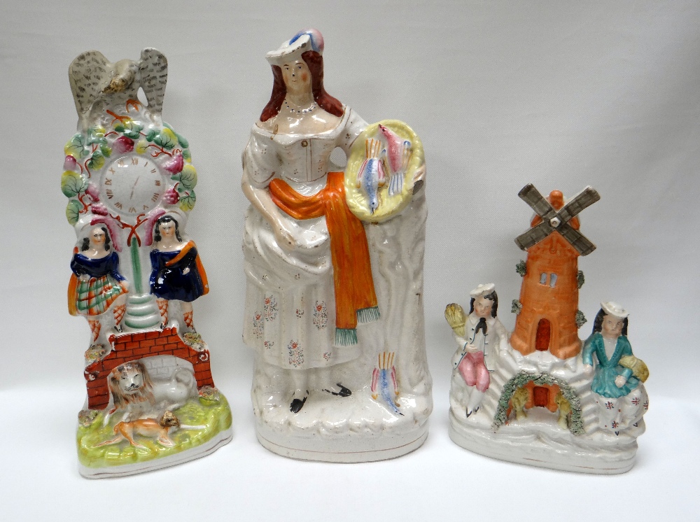 THREE NINETEENTH CENTURY STAFFORDSHIRE MODELS comprising tall clock-house group, windmill group