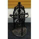 A CAST IRON UMBRELLA STAND of half-moon form with arched ornate back, 88cms high Provenance: The