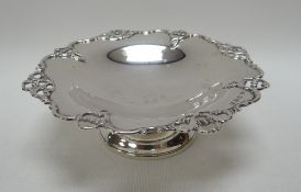 A SMALL SILVER TAZZA on a circular base with openwork scrolling border, Birmingham 1911, 3.8ozs