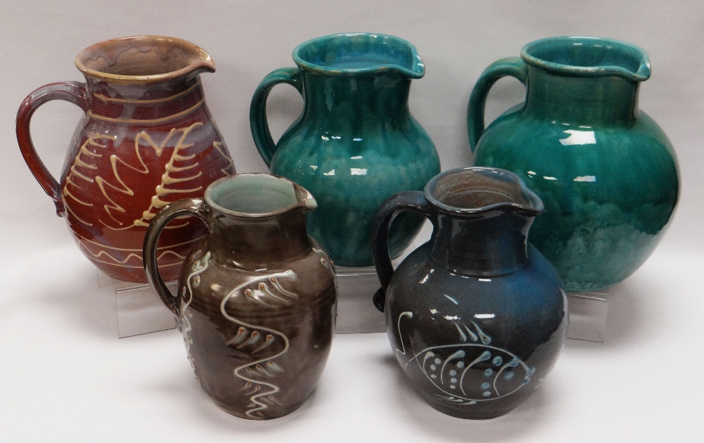 A WILLIAM FISHLEY HOLLAND STUDIO POTTERY GROUP OF FIVE JUGS in various slipware glazes and