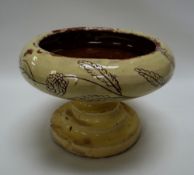 A POTTERY TAZZA BELIEVED TO BE BY BUCKLEY with cream sgraffito glaze, unmarked, 21cms diam