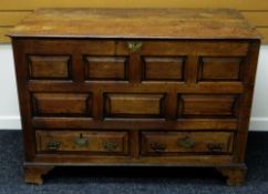 A NINETEENTH CENTURY PANELLED OAK BLANKET CHEST on bracket feet with two base drawers and hinged