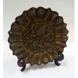 A CHINESE BRONZE ARCHAIC DISH decorated in relief with a centre dragon motif and with a fanned