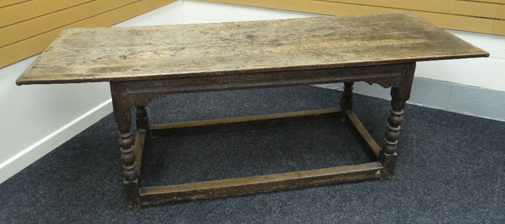 AN EARLY OAK REFECTORY TABLE on turned and block supports and with rectangular floor level