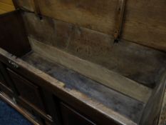 A WELSH INLAID OAK BLANKET CHEST of tri-panelled form and with a pair of base drawers bearing lion