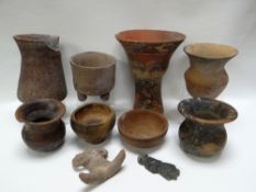 A COLLECTION OF PRE-COLOMBIAN POTTERY ITEMS including a decorated fluted vase, a three-footed