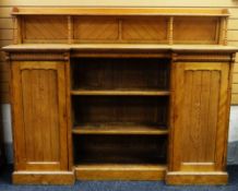 AN ARTS AND CRAFTS OAK SIDEBOARD manner of Charles Bevan composed of three centre open shelves