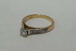 A 14k YELLOW GOLD DIAMOND RING having a centre diamond of a 0.45cts (visual estimate) and five