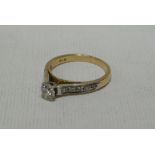 A 14k YELLOW GOLD DIAMOND RING having a centre diamond of a 0.45cts (visual estimate) and five