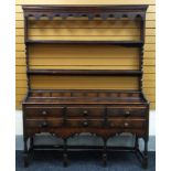 AN EARLY NINETEENTH CENTURY WELSH OAK DRESSER, the base with an arrangement of six drawers and