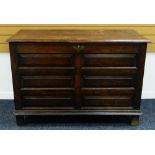 A NINETEENTH CENTURY LARGE PANELLED OAK BLANKET CHEST on stile feet with brass escutcheon and hinged