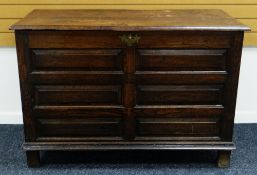 A NINETEENTH CENTURY LARGE PANELLED OAK BLANKET CHEST on stile feet with brass escutcheon and hinged