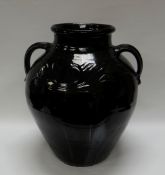 A WILLIAM FISHLEY HOLLAND STUDIO POTTERY TWIN-HANDLED VESSEL in dark glaze with sgraffito work,