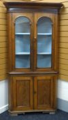 A NINETEENTH CENTURY TWO-STAGE WELSH FARMHOUSE CORNER CABINET-CUPBOARD having a two-door arch glazed