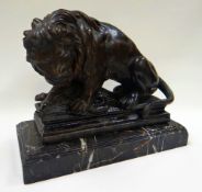 A CAST & PAINTED BRONZE SCULPTURE OF A LION KILLING A BOAR raised on a platform and applied to a