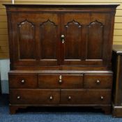AN OAK CARMARTHENSHIRE PRESS CUPBOARD having a five drawer base, the upper-cupboard with two doors