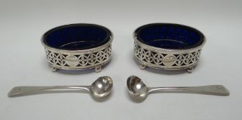 A PAIR OF OVAL SALTS & SPOONS having Bristol-blue glass liners, on ball feet and with Classical-