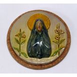 A WILLIAM FISHLEY HOLLAND STUDIO POTTERY RELIGIOUS PLAQUE in circular form with the Virgin Mary in