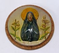 A WILLIAM FISHLEY HOLLAND STUDIO POTTERY RELIGIOUS PLAQUE in circular form with the Virgin Mary in