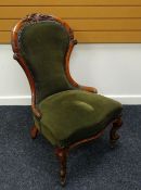 A QUEEN ANNE STYLE WALNUT SPOON CHAIR with carved rail and green upholstery