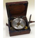 A JAMES WHITE OF GLASGOW SHIP'S COMPASS with silvered dial and brass case in a wooden and leather