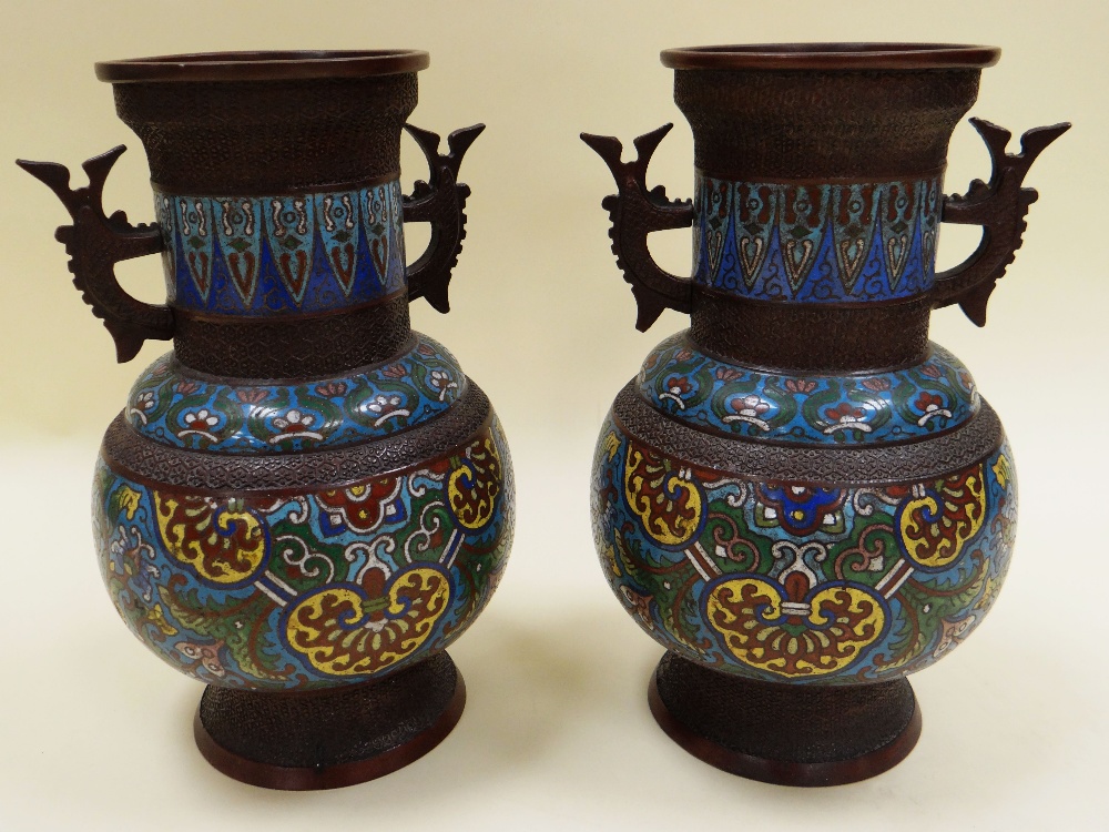 A PAIR OF CLOISONNE TWIN-HANDLED VASES decorated with three bands of polychrome enamel