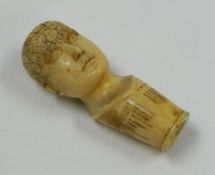 AN IVORY PHRENOLOGY WALKING CANE-HANDLE in the form of a human head, the cranium with divided