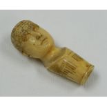 AN IVORY PHRENOLOGY WALKING CANE-HANDLE in the form of a human head, the cranium with divided