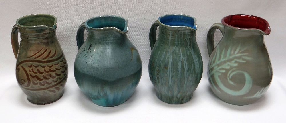 A WILLIAM FISHLEY HOLLAND STUDIO POTTERY GROUP OF FOUR JUGS in various slipware glazes, approx 22cms