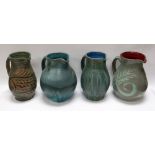 A WILLIAM FISHLEY HOLLAND STUDIO POTTERY GROUP OF FOUR JUGS in various slipware glazes, approx 22cms