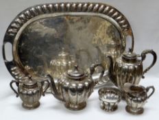 A MEXICAN SILVER SIX PIECE TEASET comprising oval tray, teapot, hot-water jug, sugar basin, lidded
